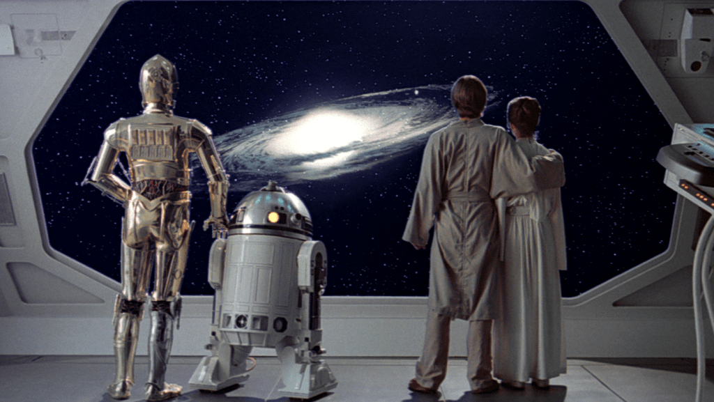 End shot from Empire Strikes Back. C3PO, R2D2, Luke, and Leia stand at a starship window looking out at a spiral galaxy. Luke's arm is around Leia's shoulders, and C3PO is similarly resting a hand on R2D2. It is both sad and hopeful as they contemplate rescuing Han from the clutches of Jabba the Hutt.